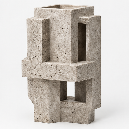 PLIOXOO® concrete geometric block vase on white surface – full product view showing four interlocking rectangular columns with open windows and cruciform base in speckled grey concrete